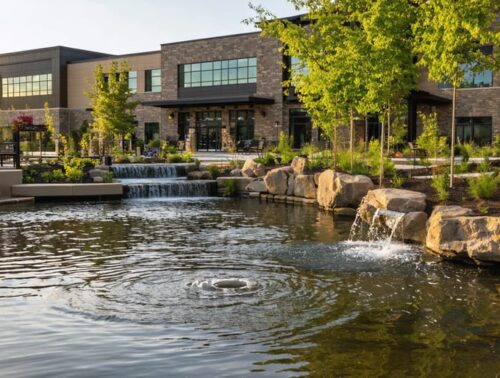 "Assisted living facility with a water garden and fire safety equipment visible, highlighting safety measures in a serene environment."